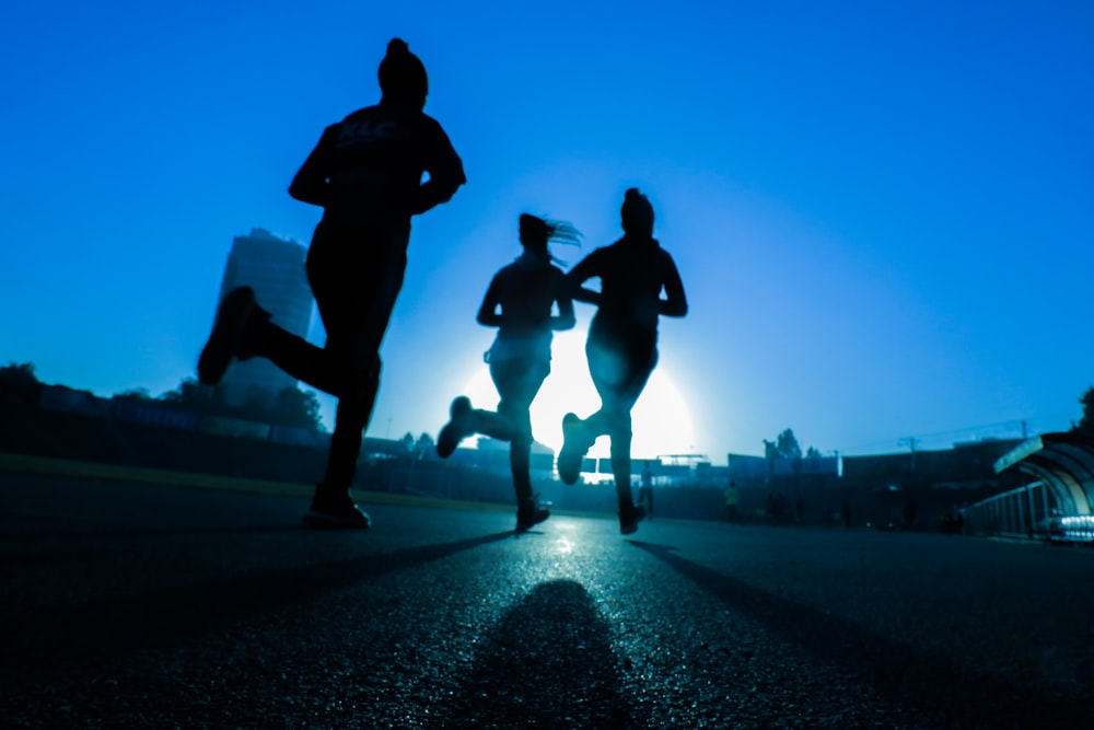 Client running confidently outdoors at sunrise after completing her program