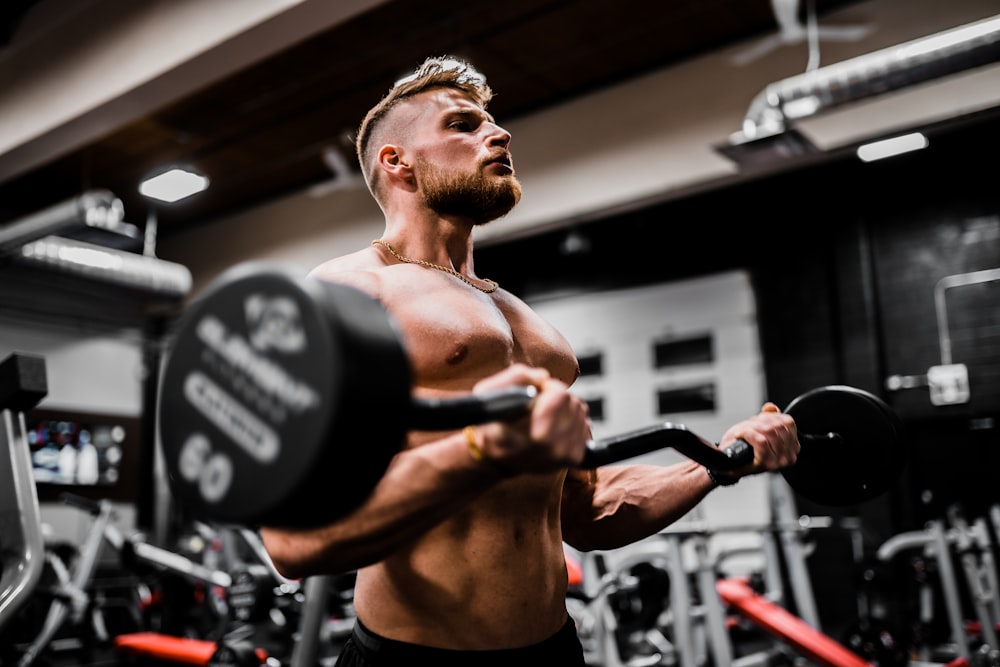 Client lifting a curl bar with confidence in the studio