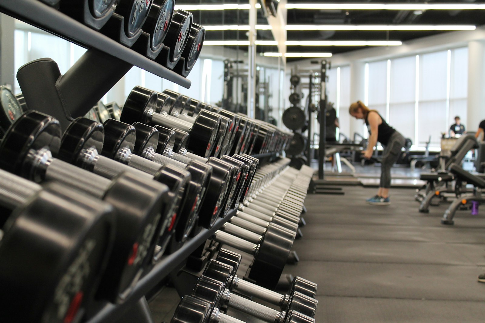 Rows of dumbbells in a clean, modern training studio